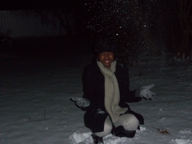 Charnae Sanders is enjoying the cold Michigan weather as the snow falls to the ground. Photo: April Jackson